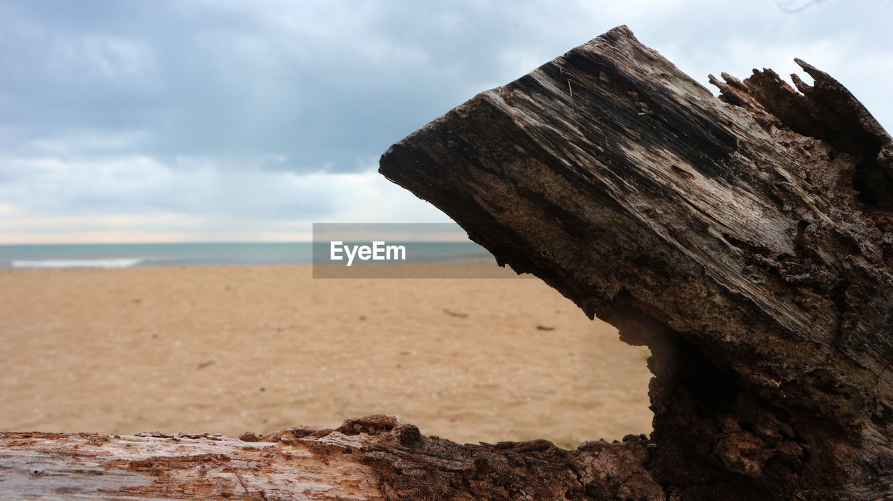 Scenic view of rocky beach against sky