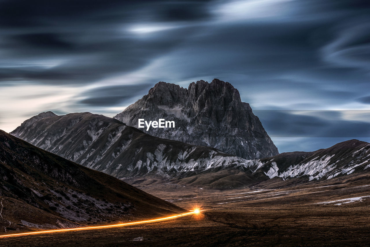 SNOWCAPPED MOUNTAINS AGAINST SKY DURING WINTER