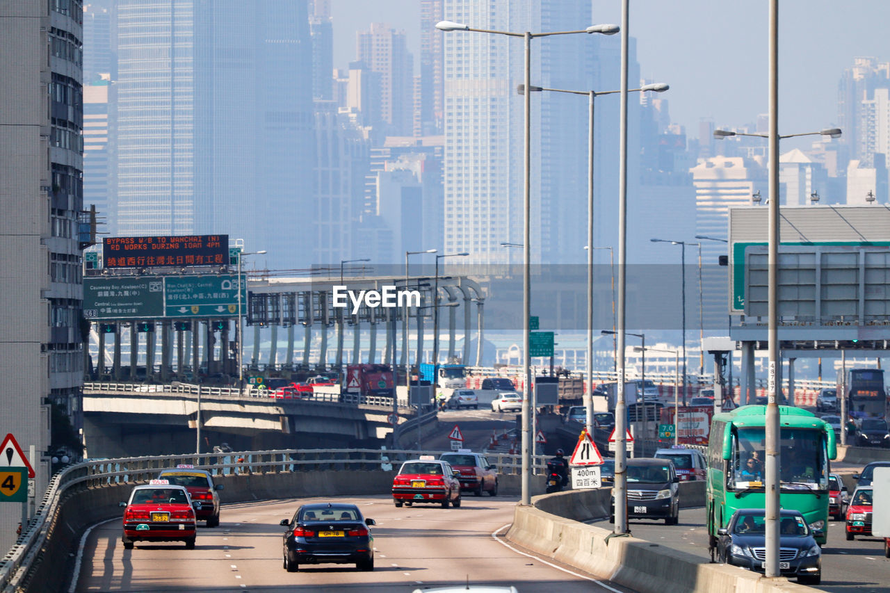 Traffic on road against buildings in city