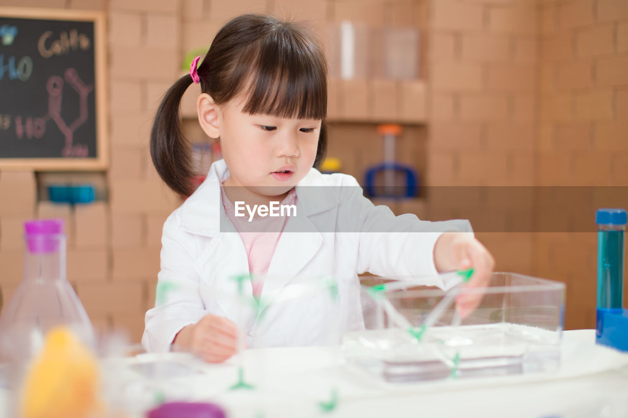 Young girl play science experiments for homeschooling