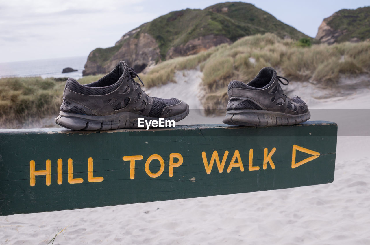 INFORMATION SIGN ON SAND AT BEACH