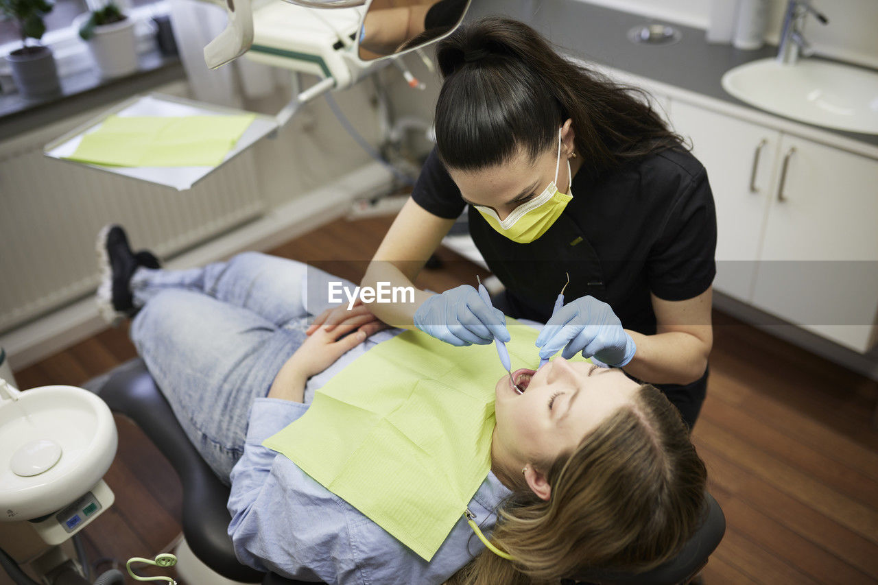 Female dentist with patient in office