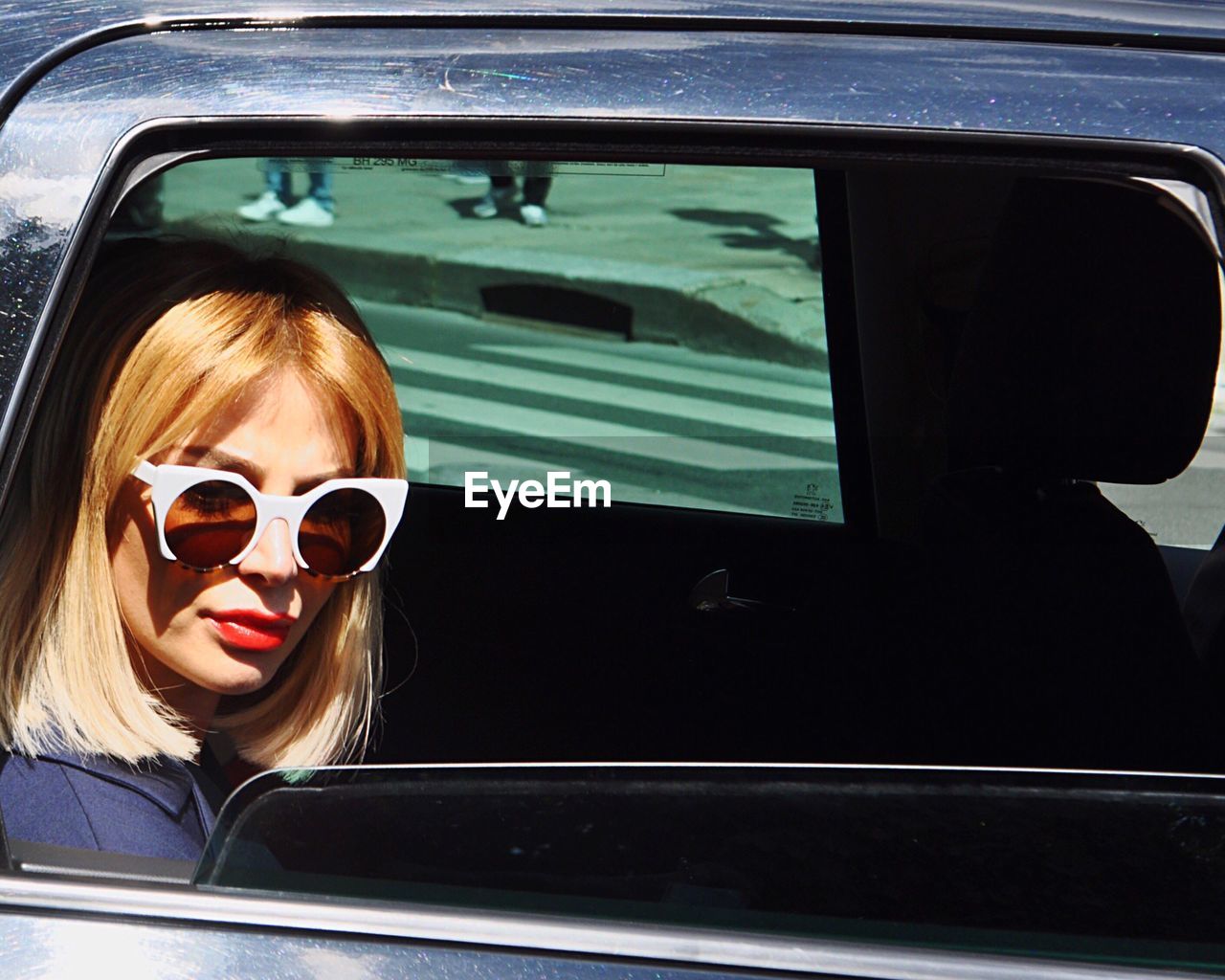 Portrait of young woman sitting in car