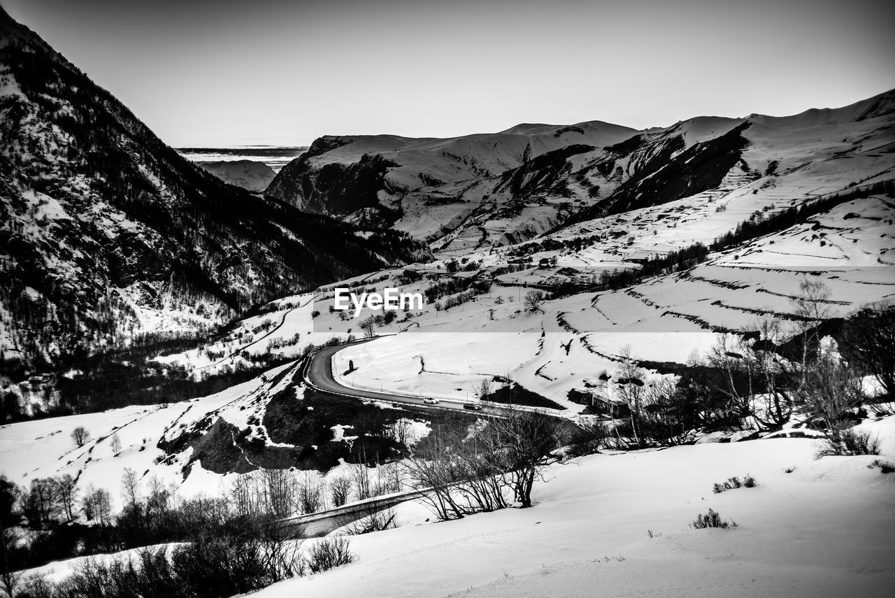 Scenic view of snow covered mountains against sky