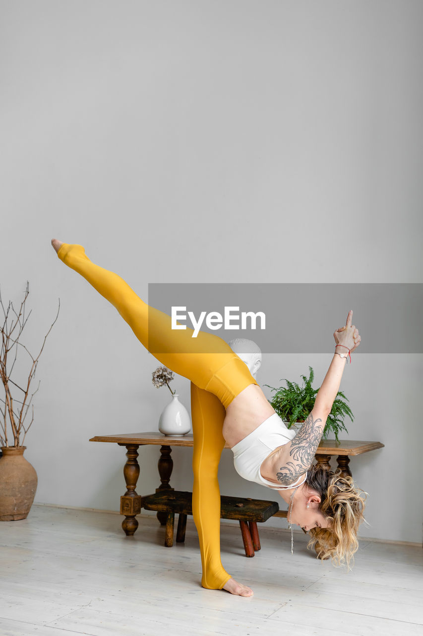 Beautiful woman performing yoga at home