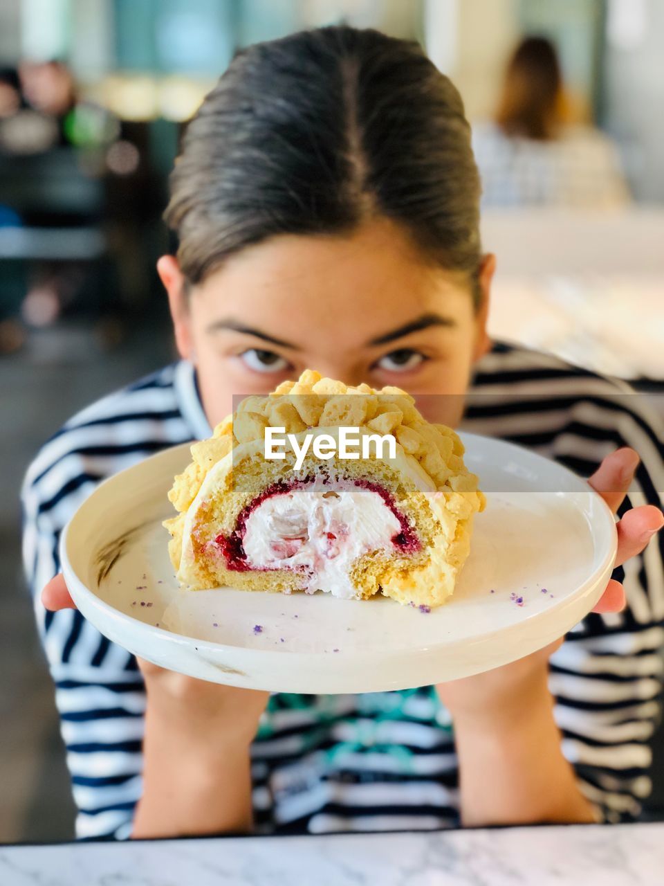 Portrait of girl holding sweet food in plate