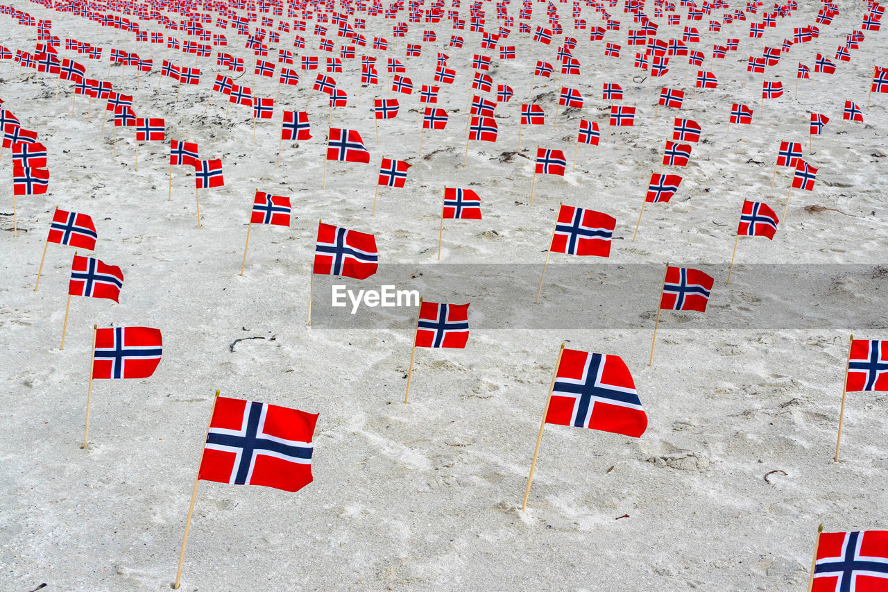 High angle view of red flags on sand at beach