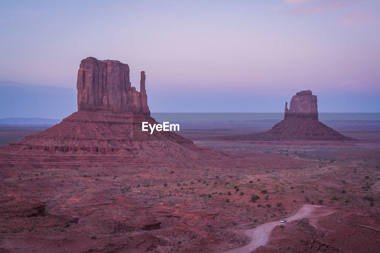 ROCK FORMATIONS IN DESERT AGAINST SKY