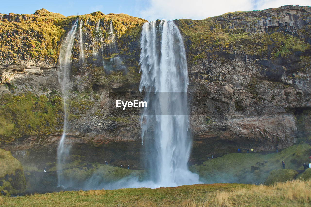 SCENIC VIEW OF WATERFALL AGAINST CLEAR SKY