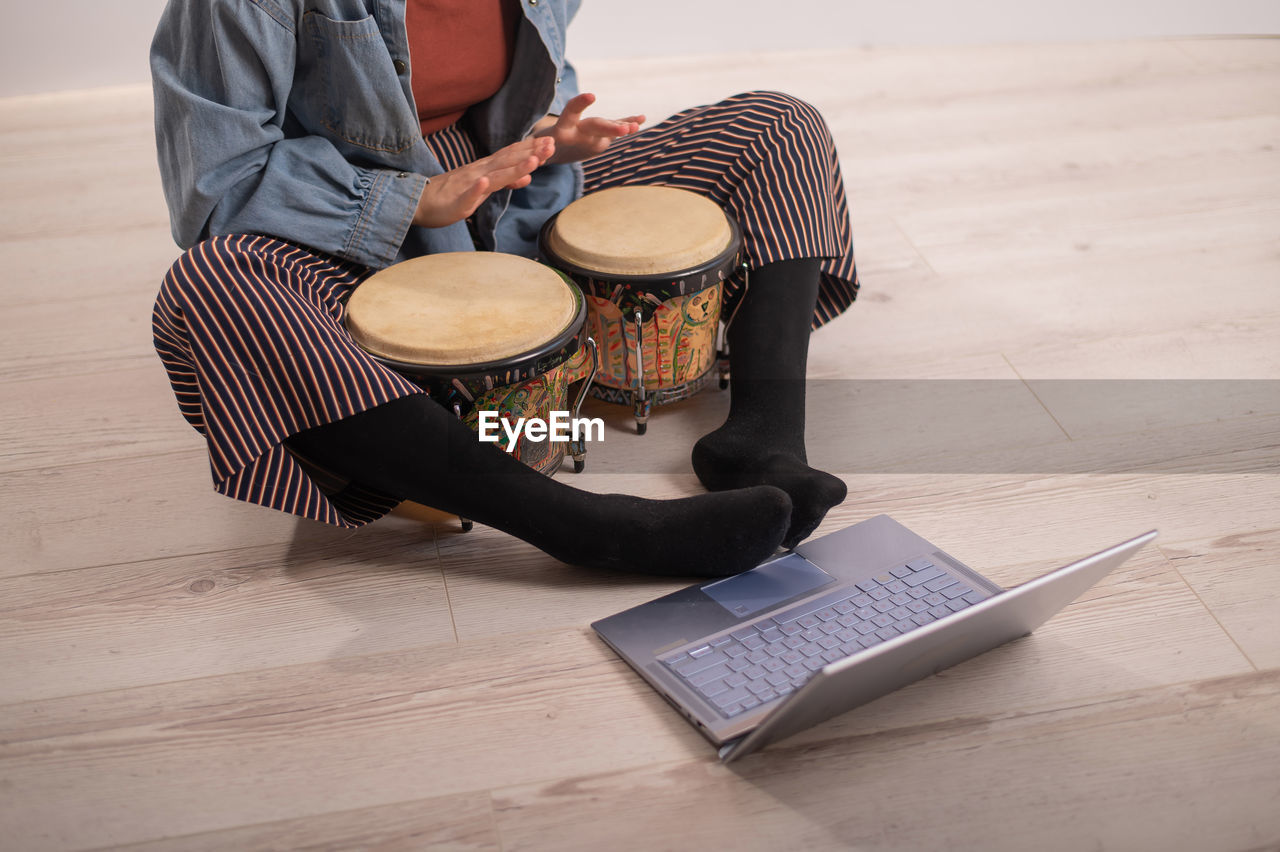 High angle view of woman playing drum