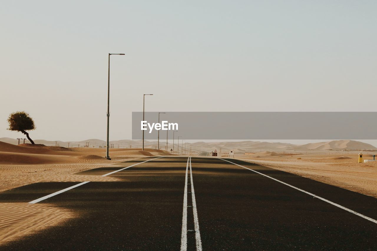 Empty road against clear sky