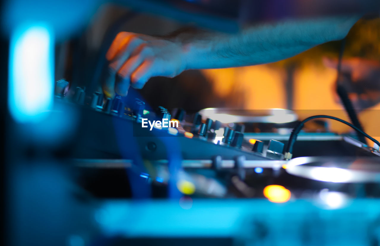 Midsection of man playing music in nightclub