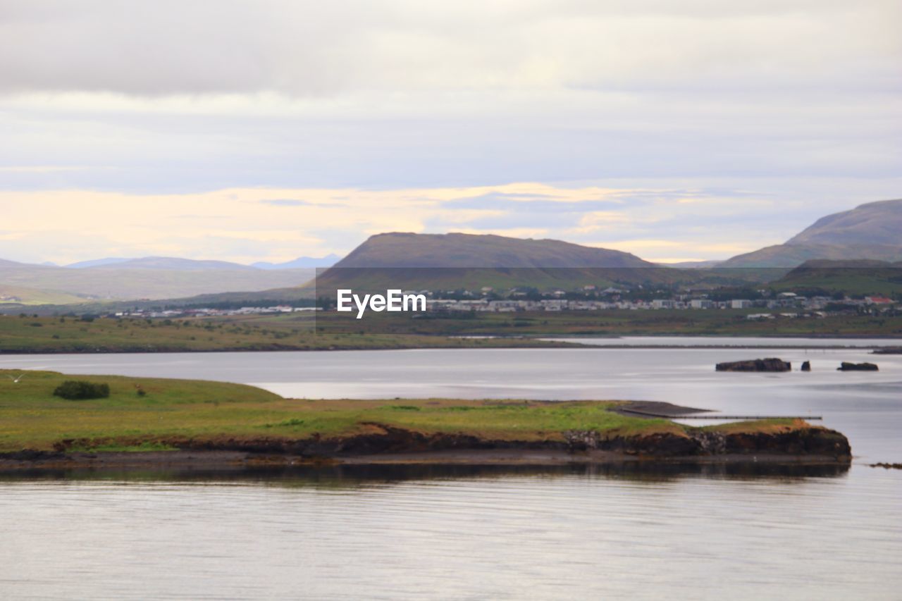 Scenic view of lake and mountains against sky