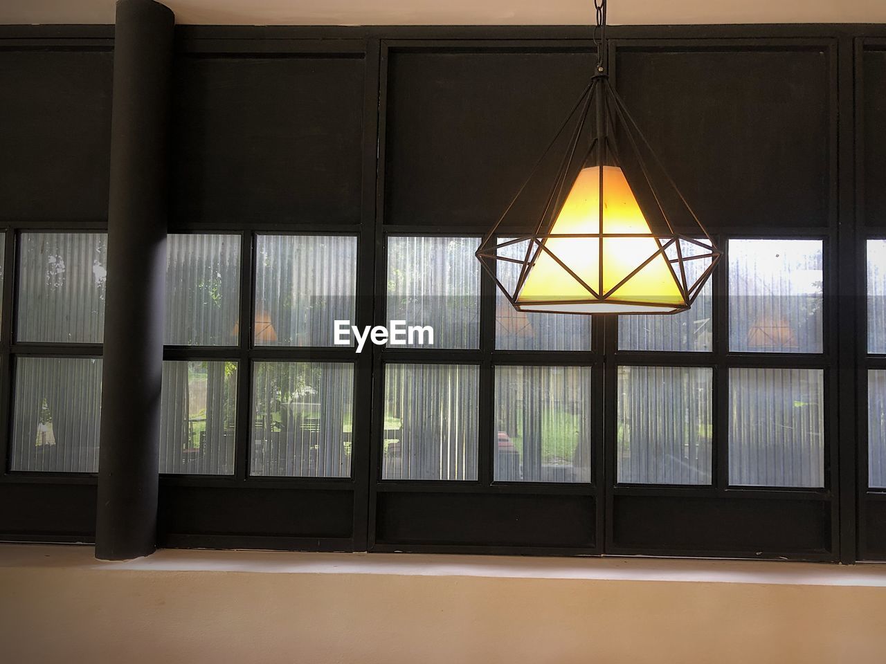 ILLUMINATED PENDANT LIGHTS HANGING ON CEILING OF BUILDING