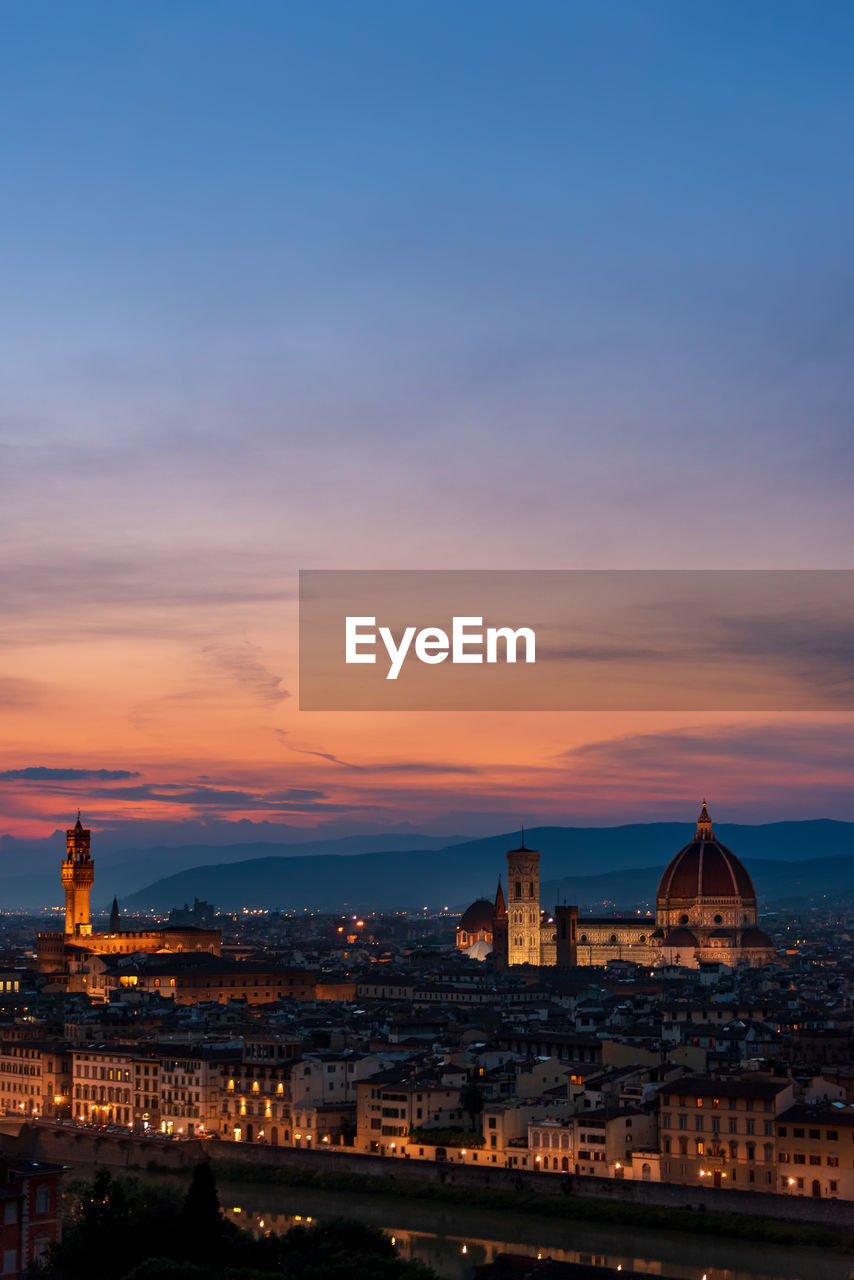 Florence sunset with lungarno, the cathedral and palazzo vecchio illuminated