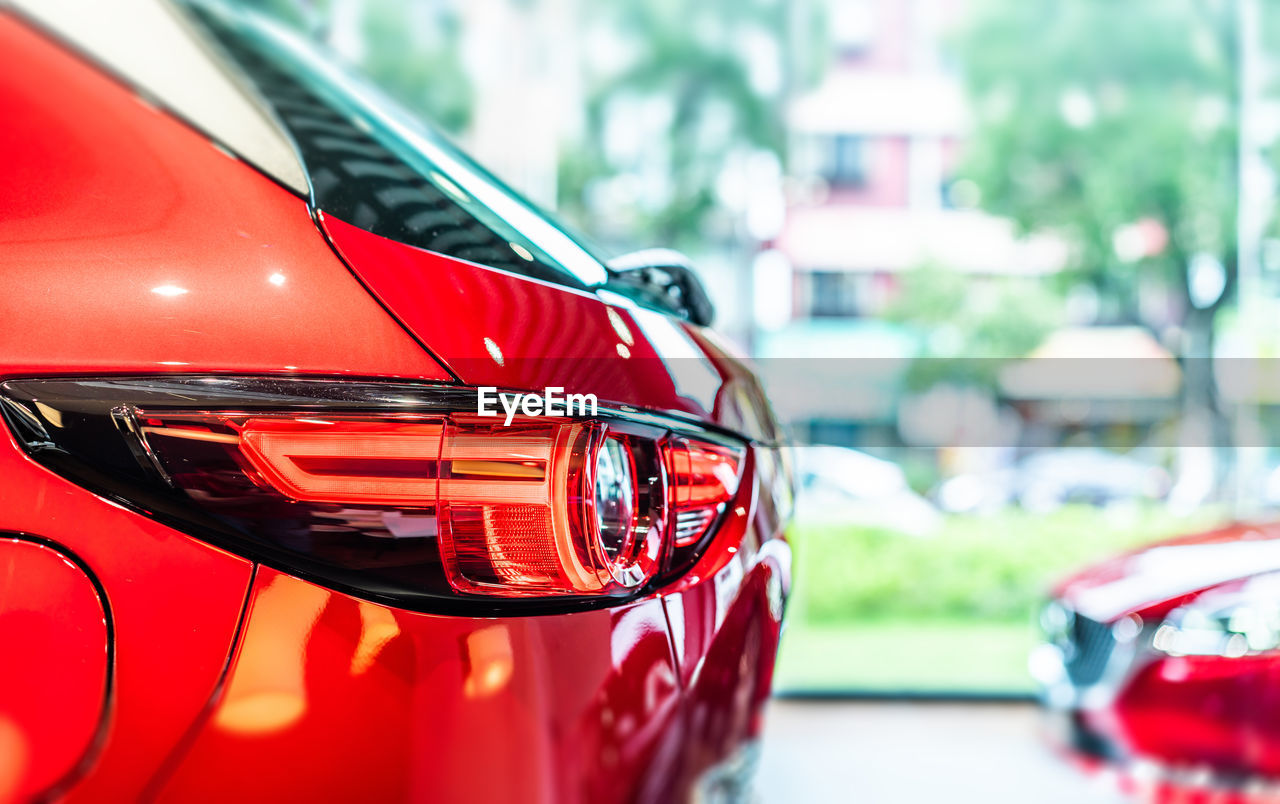 CLOSE-UP OF RED CAR ON GLASS