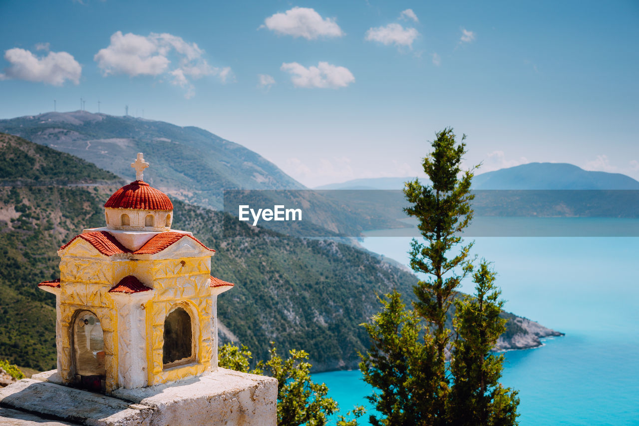 Church at beach against mountains and sky