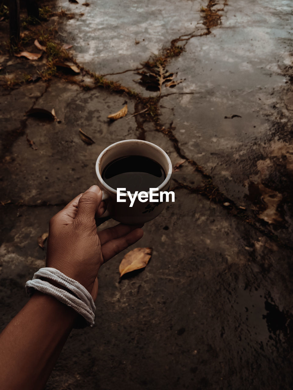 Cropped hand of woman and coffee