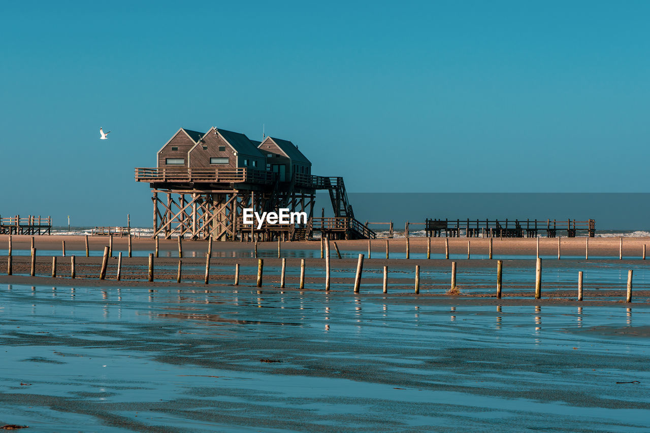 Pile dwelling on the beach of sankt peter-ording in germany.