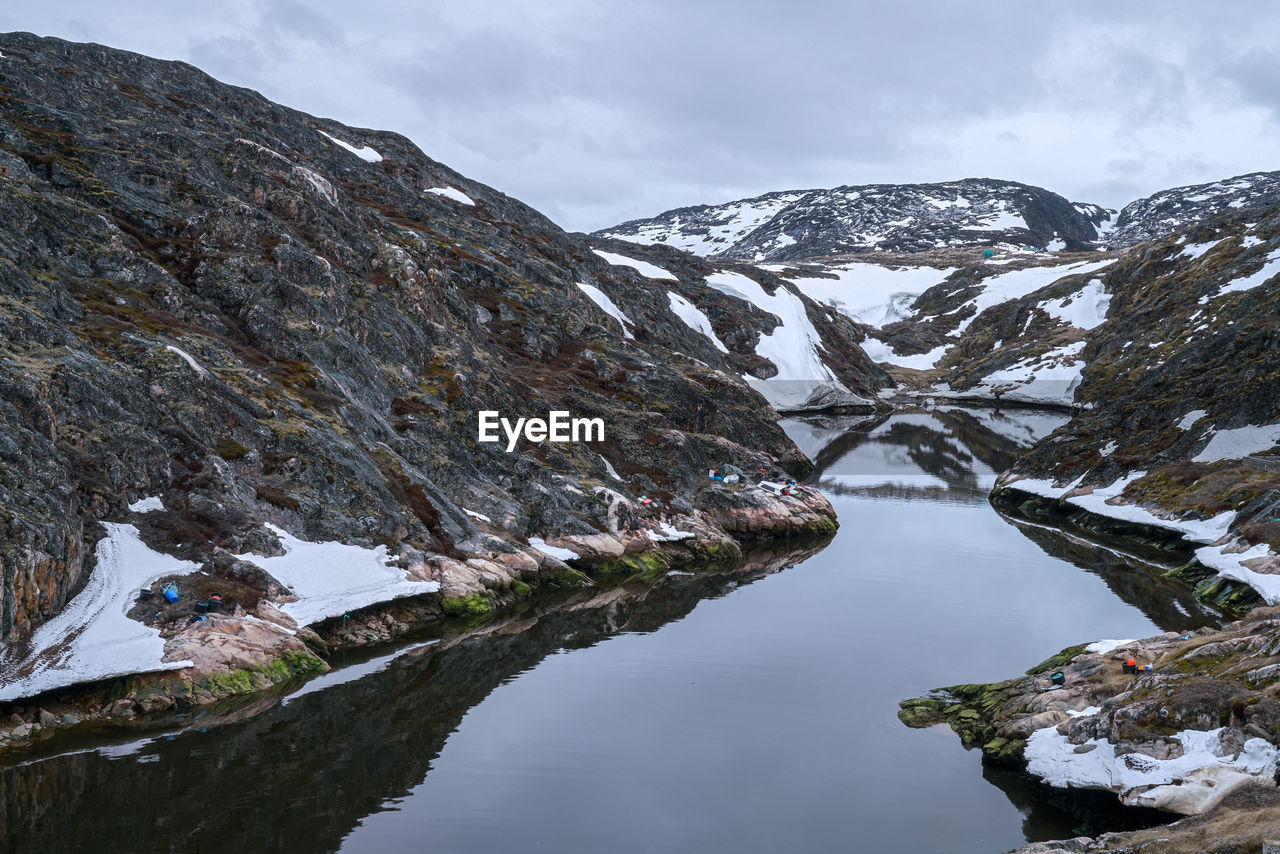 Scenic view of river flowing through mountains