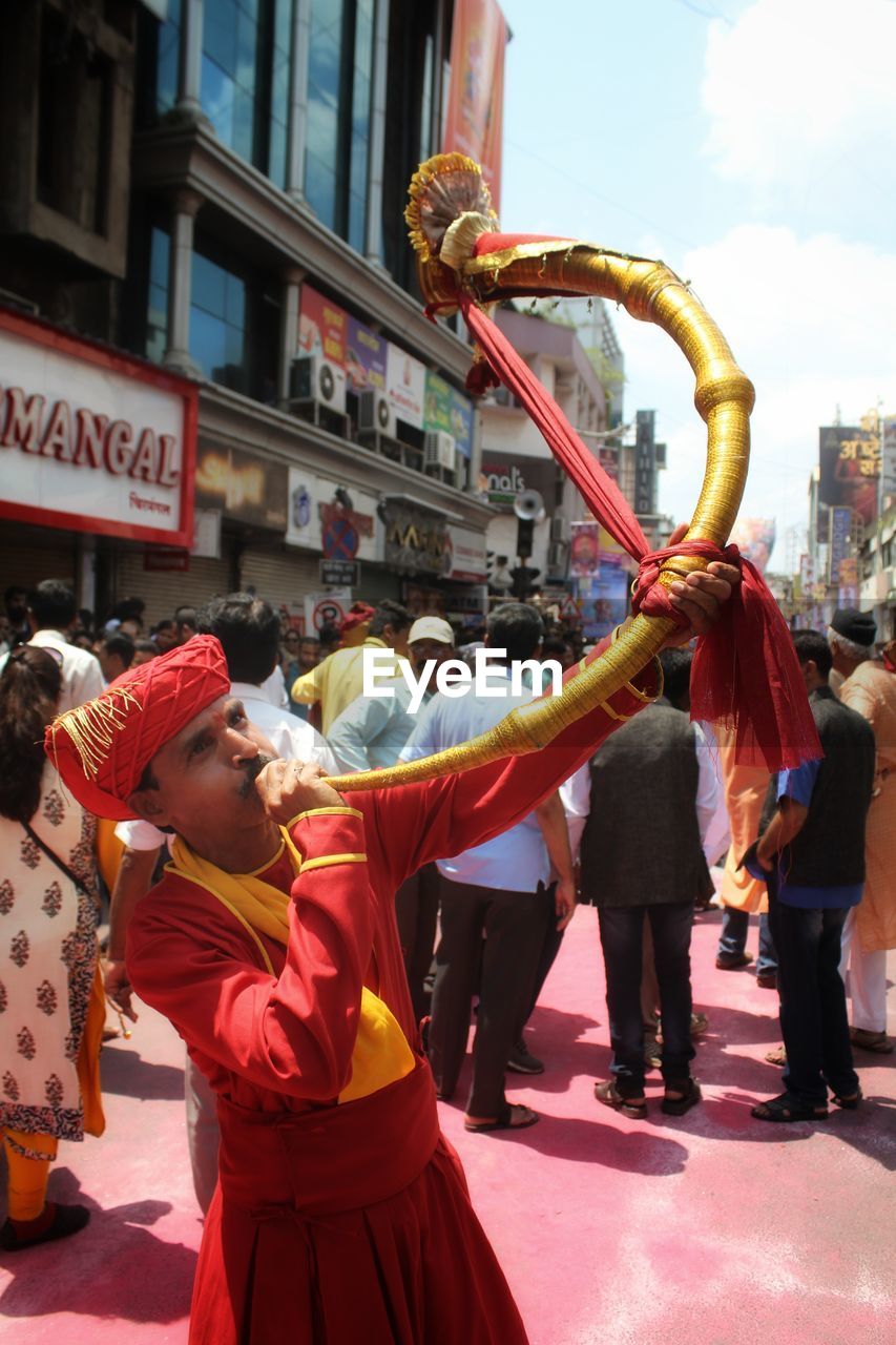 REAR VIEW OF PEOPLE AT STREET MARKET IN CITY