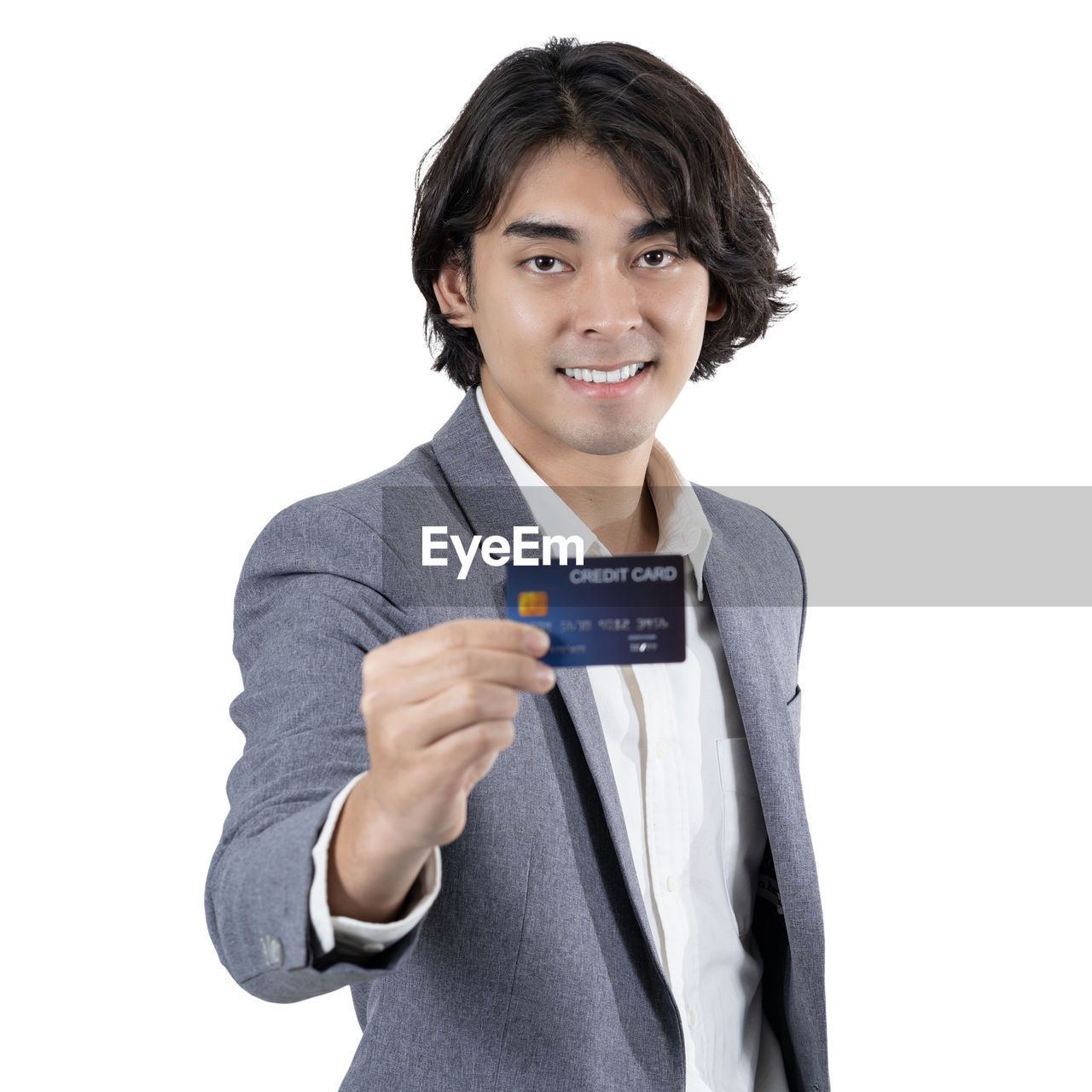 white background, one person, studio shot, smiling, cut out, portrait, outerwear, sleeve, clothing, looking at camera, happiness, indoors, adult, finger, holding, waist up, young adult, communication, hand, front view, emotion, cheerful, business, person, standing, women, casual clothing, t-shirt, showing, technology, positive emotion, smile, men, copy space, finance, collar, business finance and industry