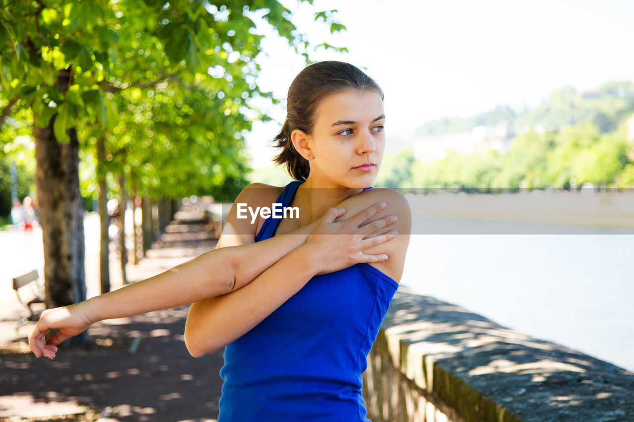 Teenage girl exercising in park