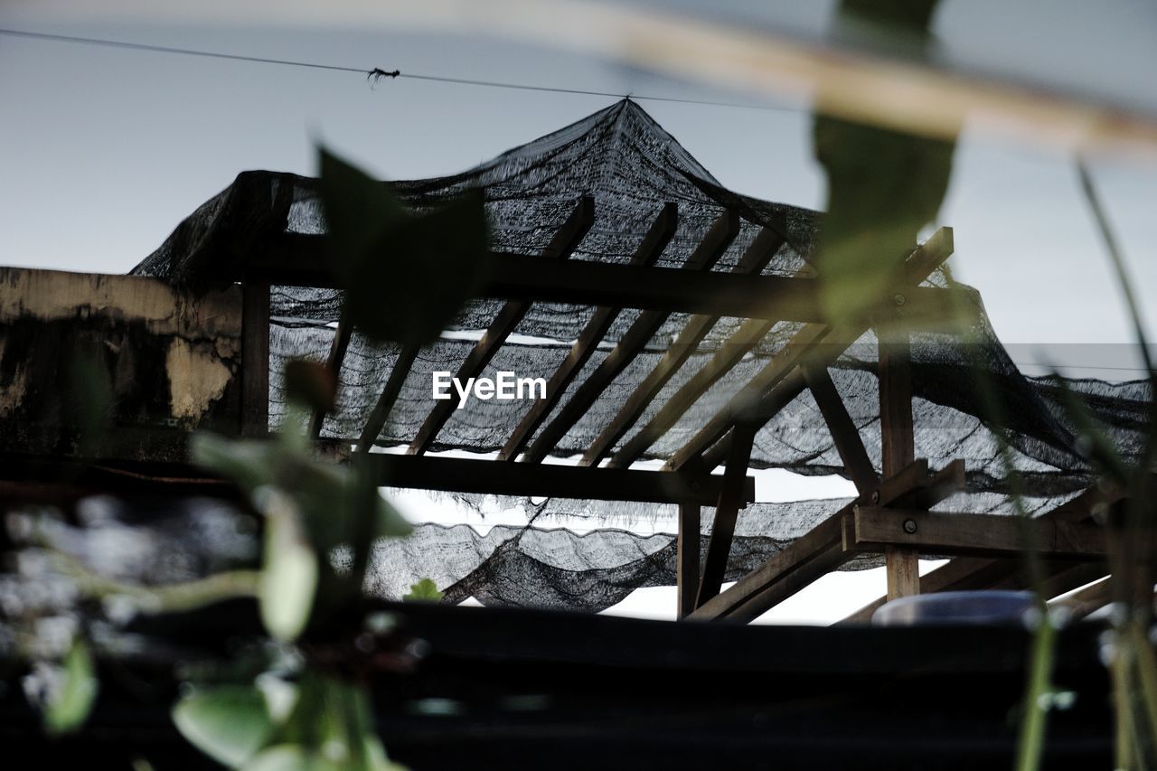 CLOSE-UP OF ROOF AGAINST BUILT STRUCTURES