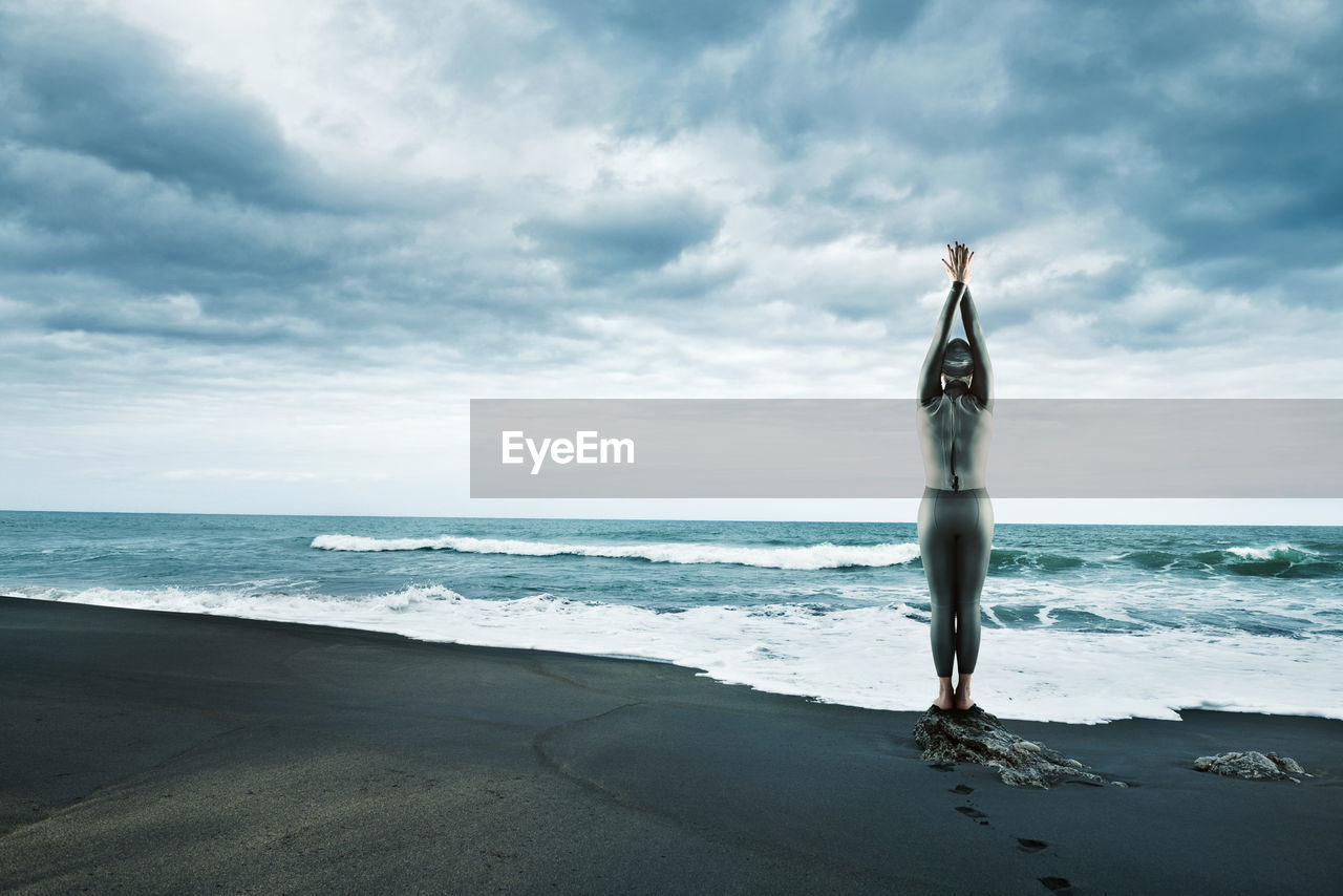 Mi adult woman n wetsuit at beach