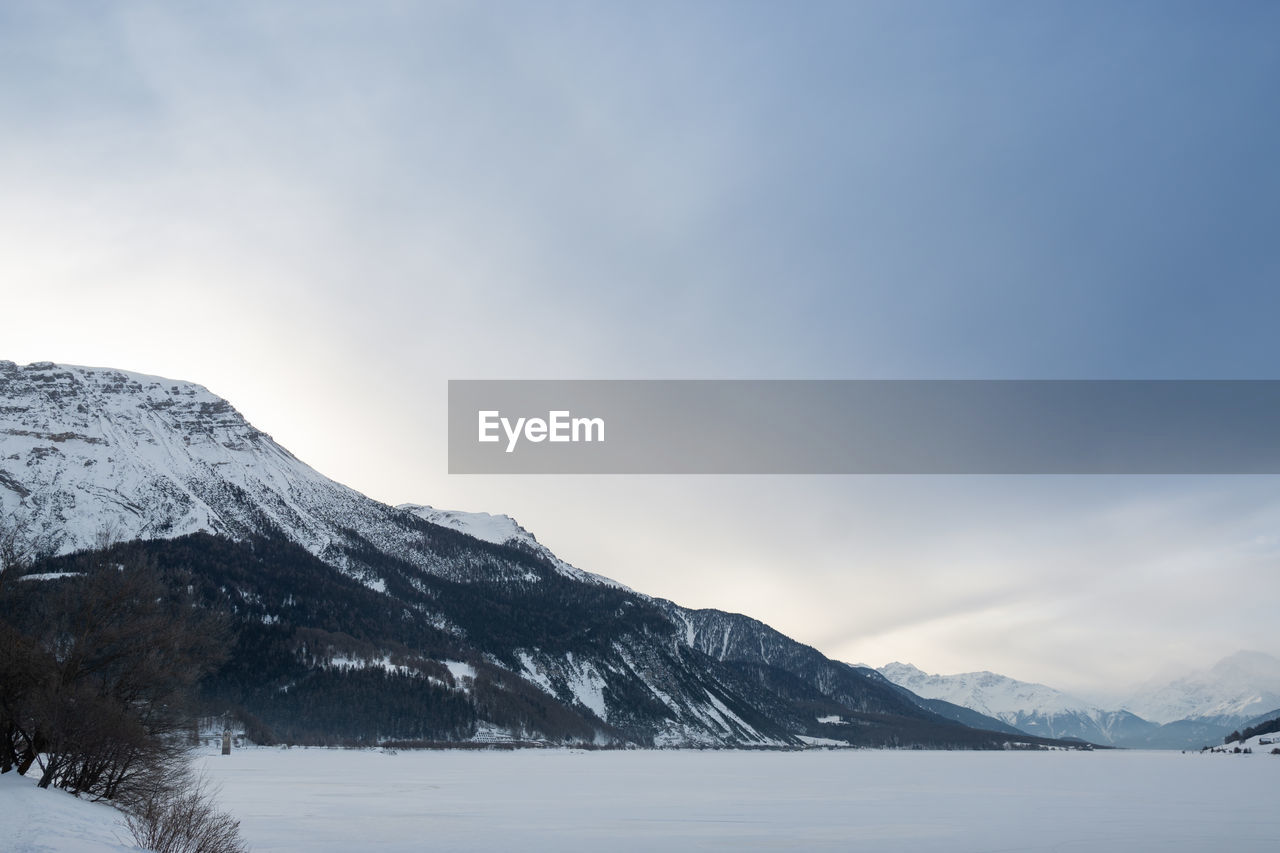 Scenic view of snowcapped mountains against sky during winter