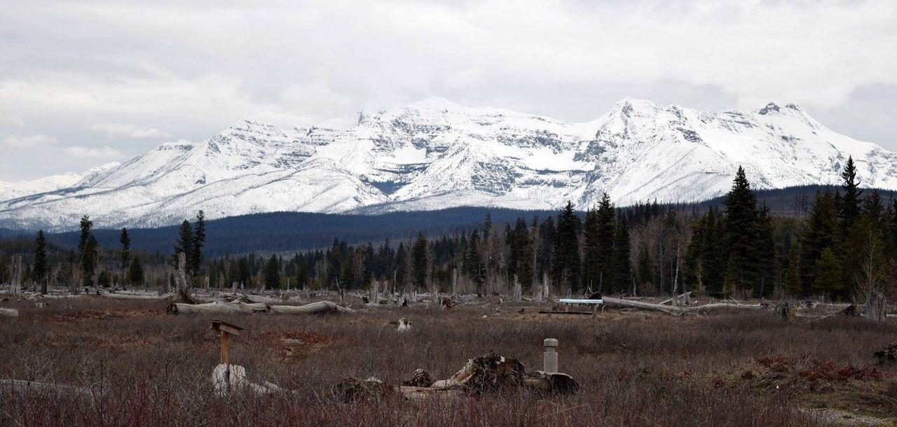 Snow covered mountains against cloudy sky