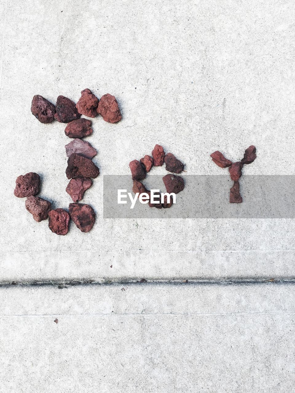 High angle view of text made with stones on footpath