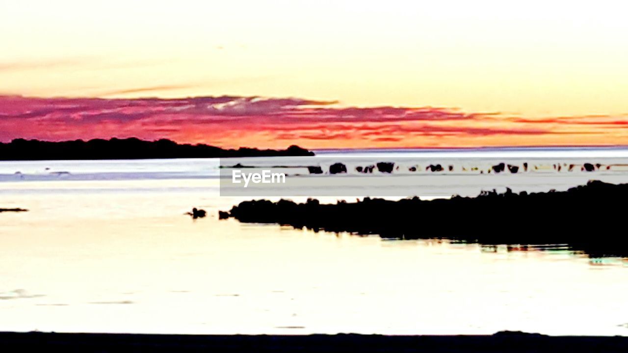 SCENIC VIEW OF SUNSET OVER SEA