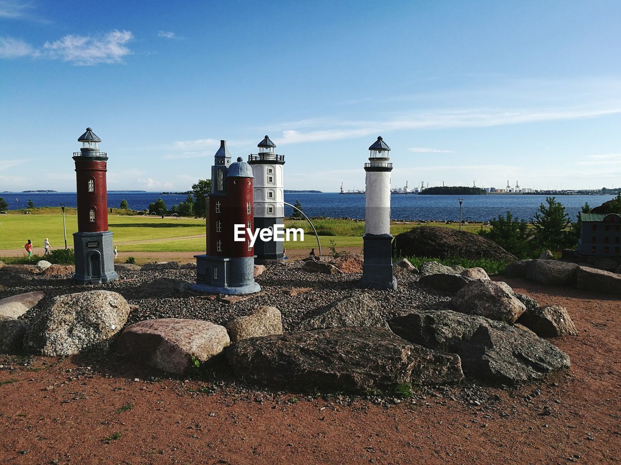 Lighthouse by sea against sky