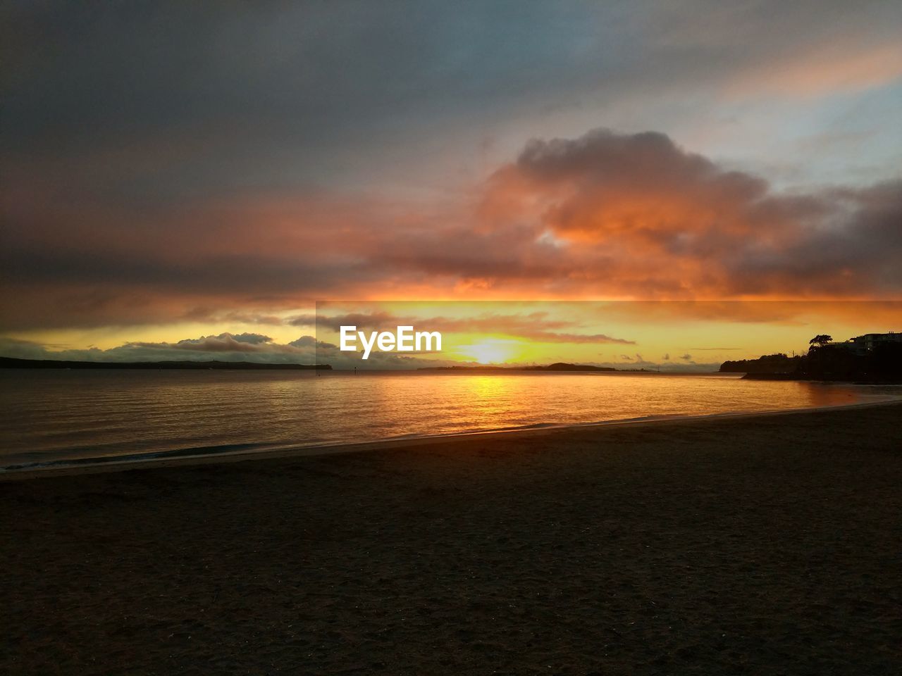 SCENIC VIEW OF BEACH DURING SUNSET