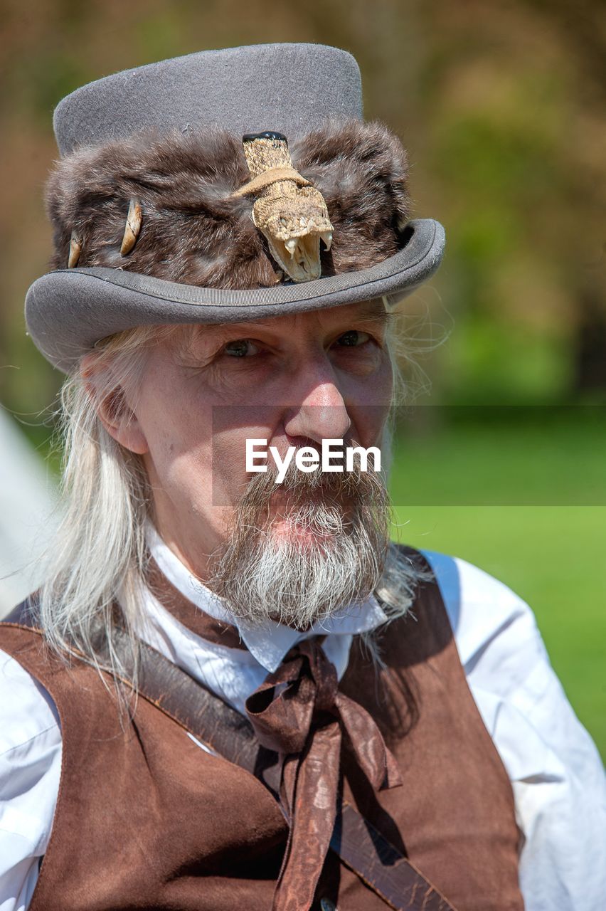 Portrait of bearded mature man wearing hat outdoors