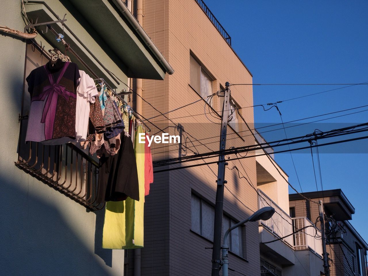 Clothes hanging by window of building