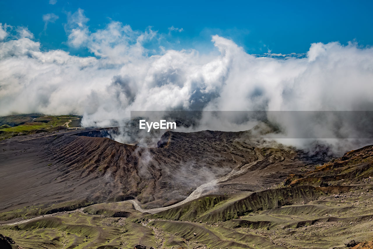Scenic view on volcanic landscape, clouds in aso crater, aso town in kyushu, japan