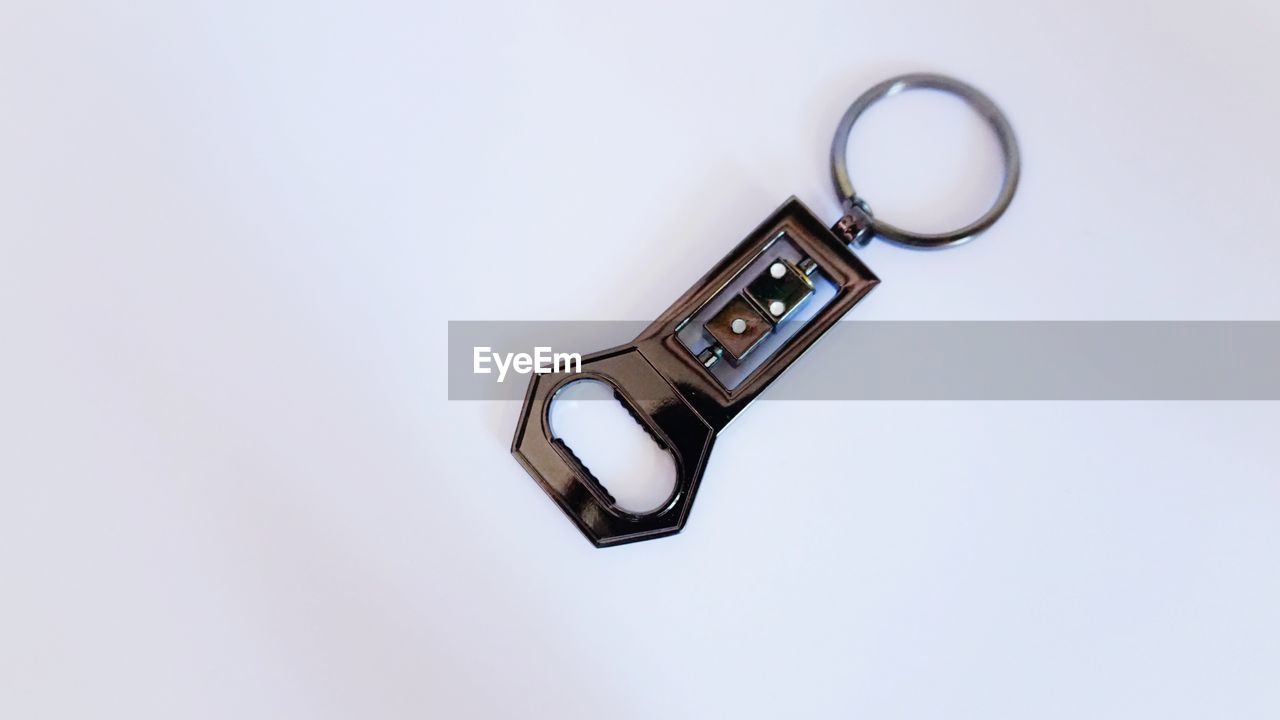 LOW ANGLE VIEW OF CLOCK ON ELECTRIC LAMP AGAINST WHITE BACKGROUND