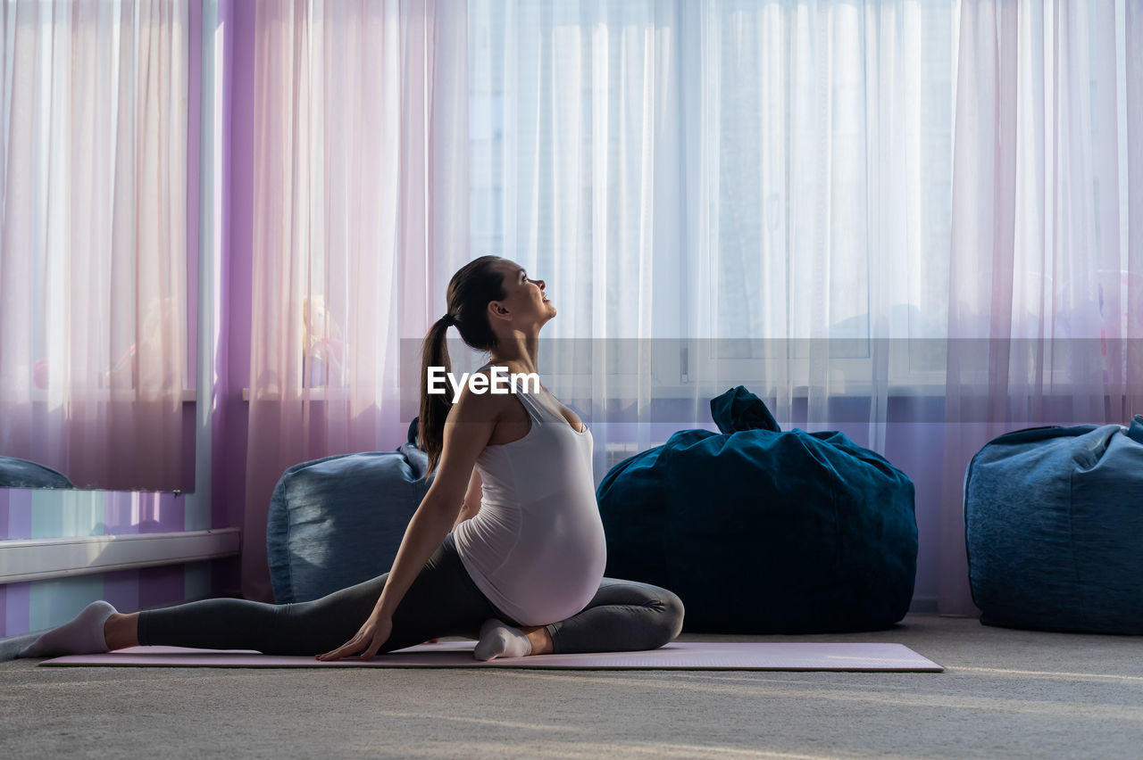 Pregnant woman exercising at home