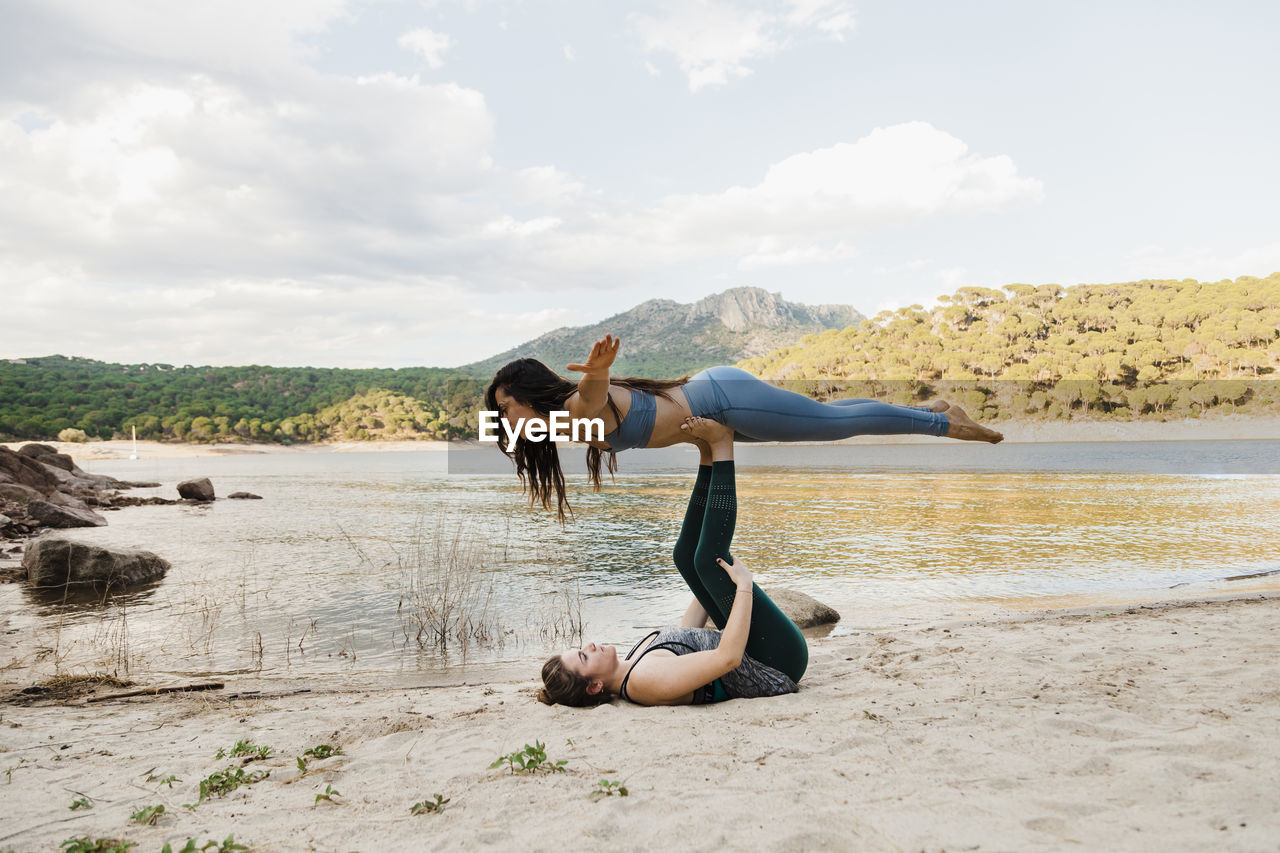 Young women doing acroyoga