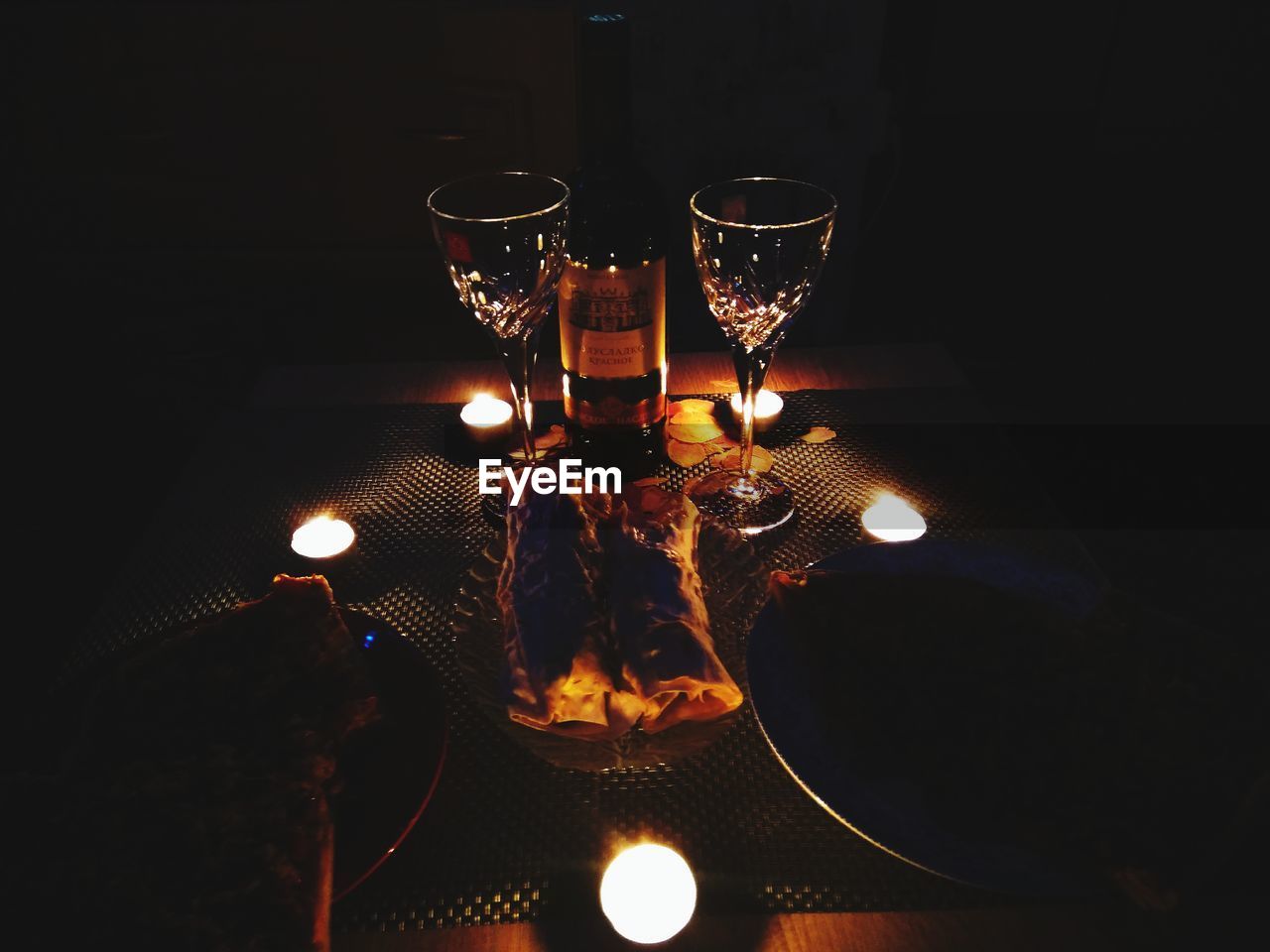 CLOSE-UP OF ILLUMINATED LAMPS ON TABLE