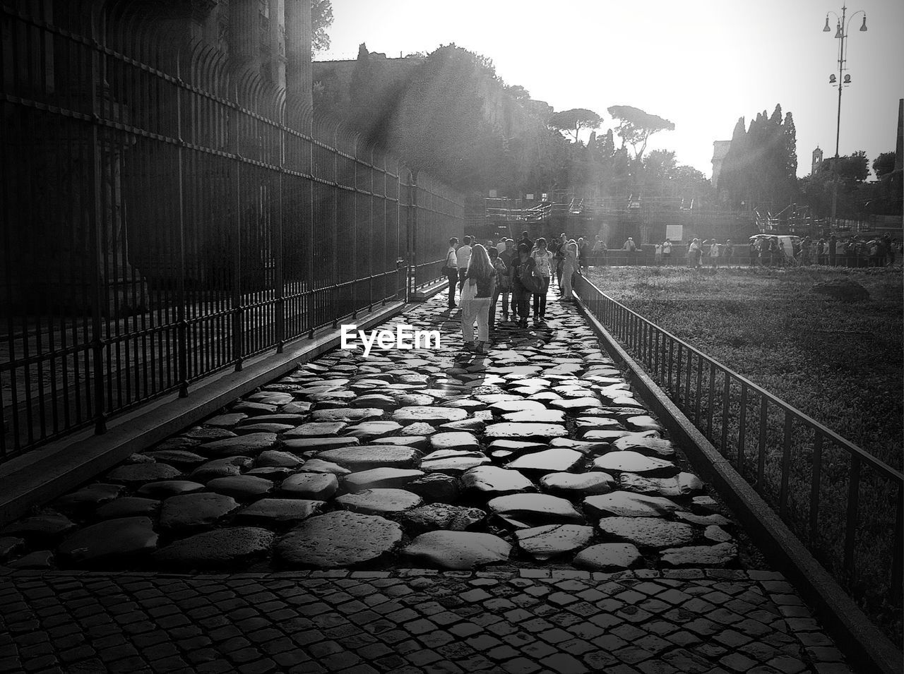 People walking on cobblestone street