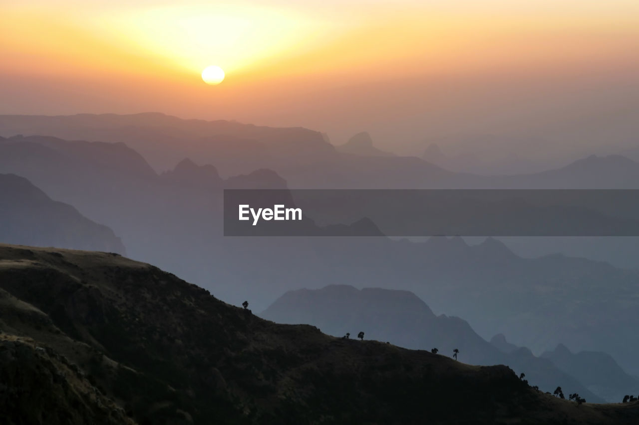 SILHOUETTE MOUNTAINS AGAINST SKY DURING SUNSET