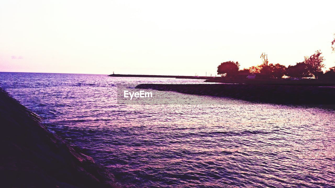 Scenic view of calm sea against clear sky