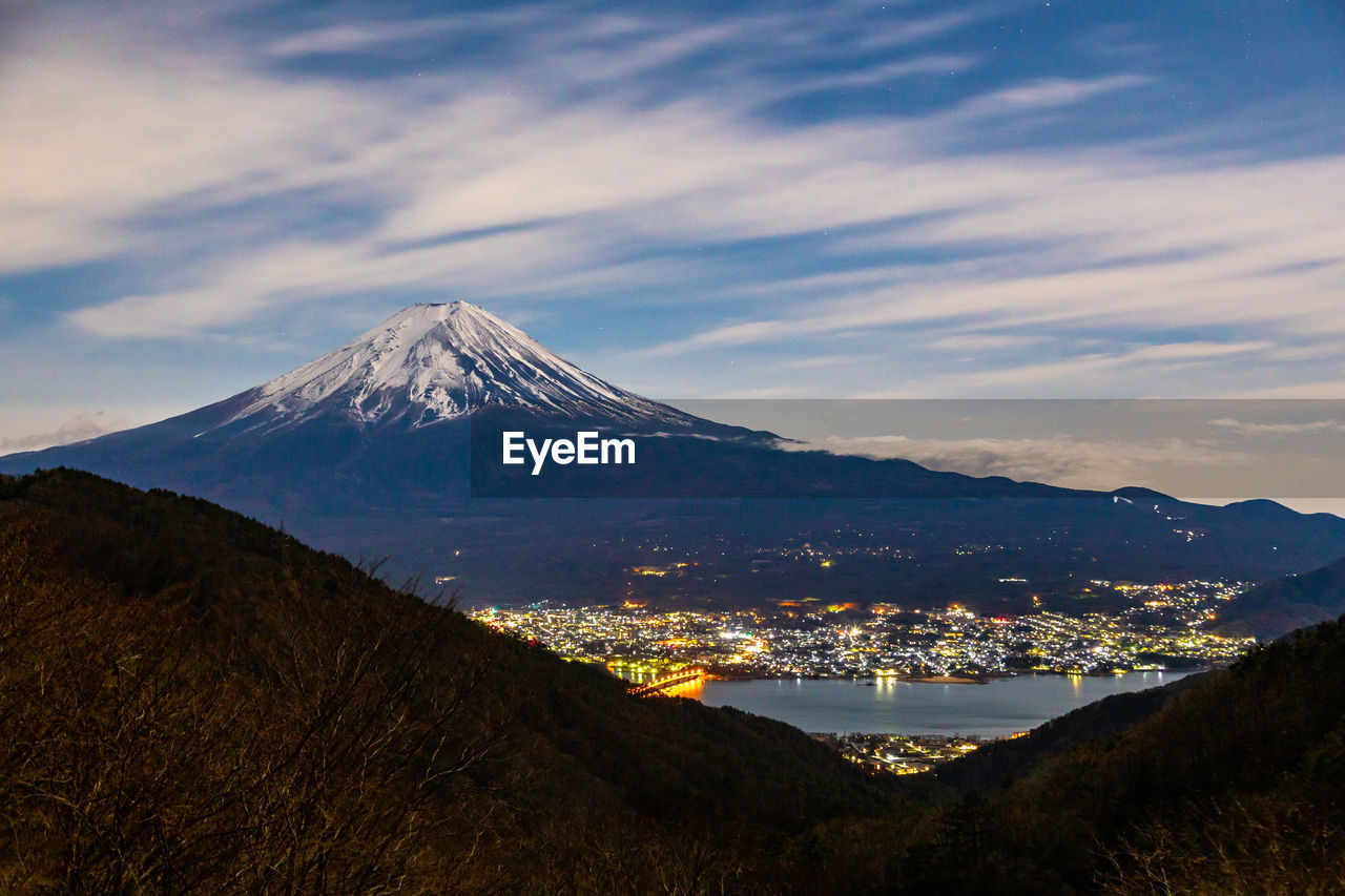 Night clouds moving behind mount fuji at kawaguchigo, japan