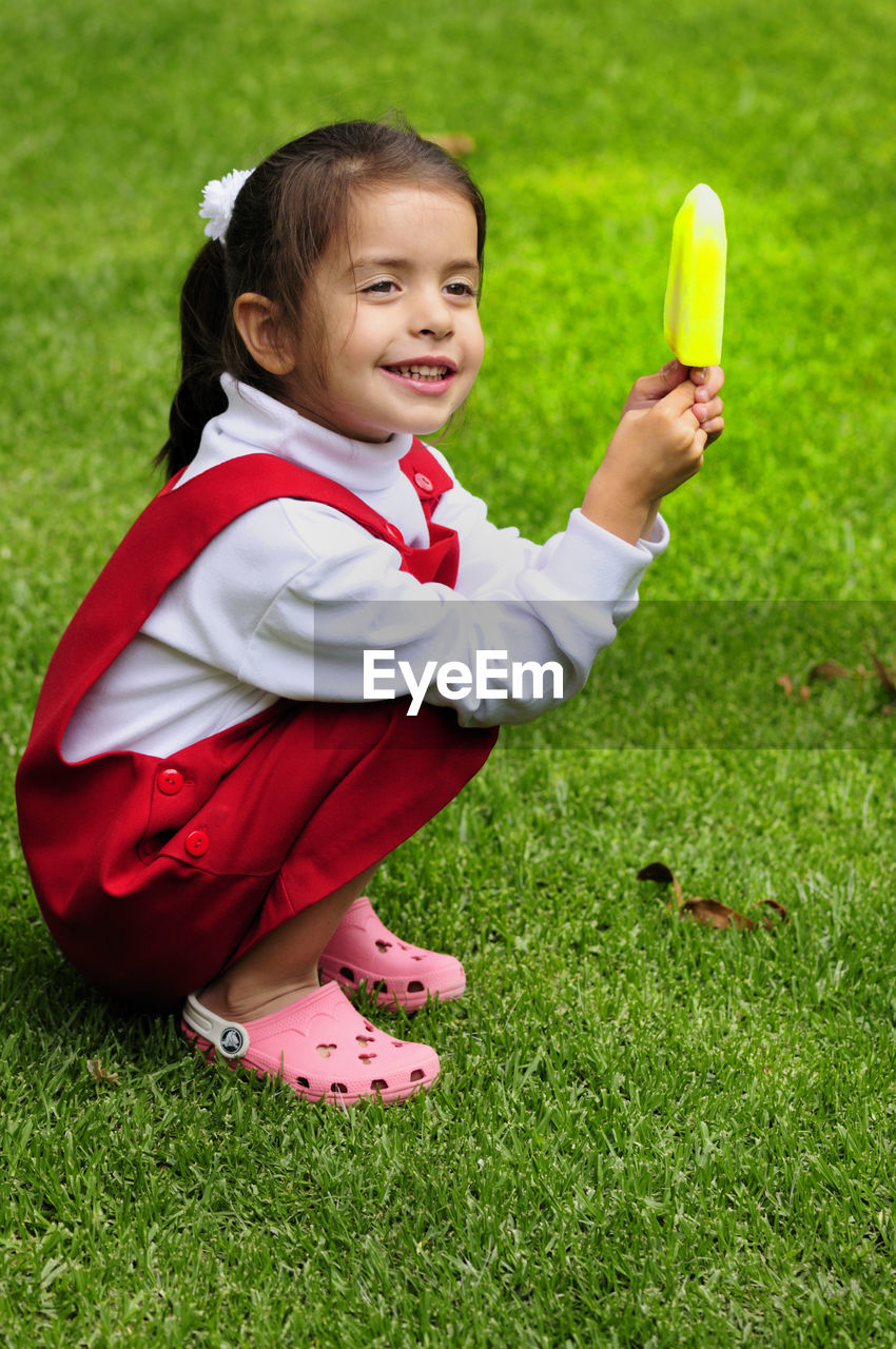 Full length of girl crouching on land