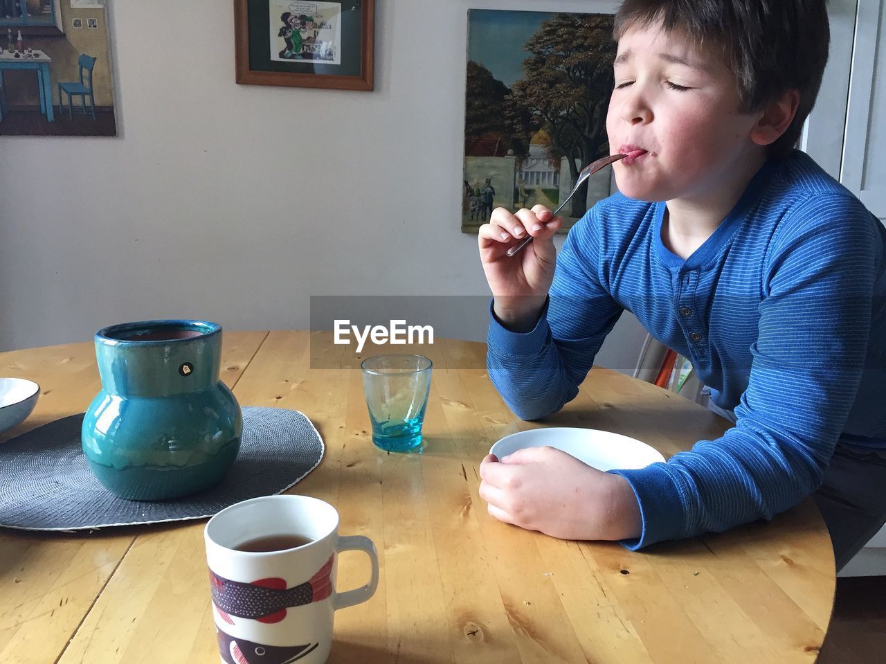 Boy having breakfast at table