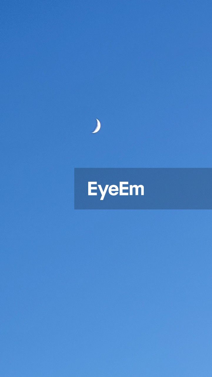 sky, blue, moon, clear sky, copy space, low angle view, no people, crescent, nature, beauty in nature, flying, scenics - nature, tranquility, space, outdoors, tranquil scene, half moon, mid-air, astronomy