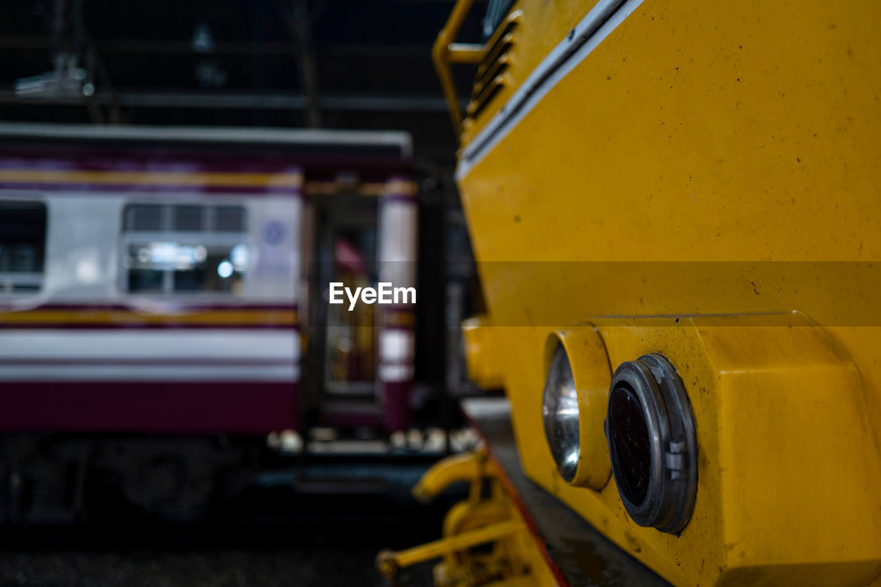 CLOSE-UP OF TRAIN IN CITY AGAINST YELLOW SKY